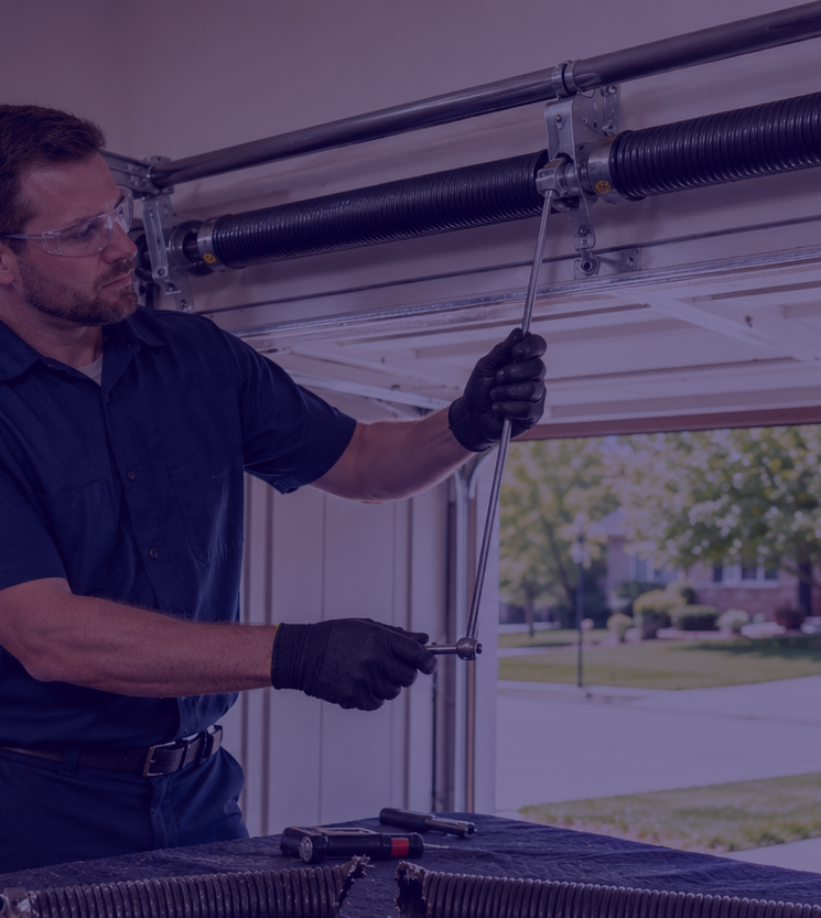 Technician checking garage door spring hardware